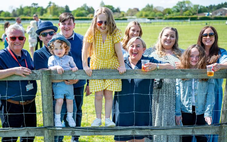 A family enjoying the races in the sunshine.